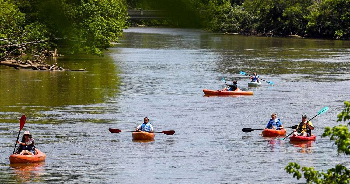 Raft guides turned rescuers shovel Appalachian river mud and clear trees in Florida