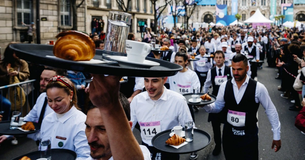 Paris waiters race through the streets as French capital celebrates the city’s life and soul ahead of Olympics 