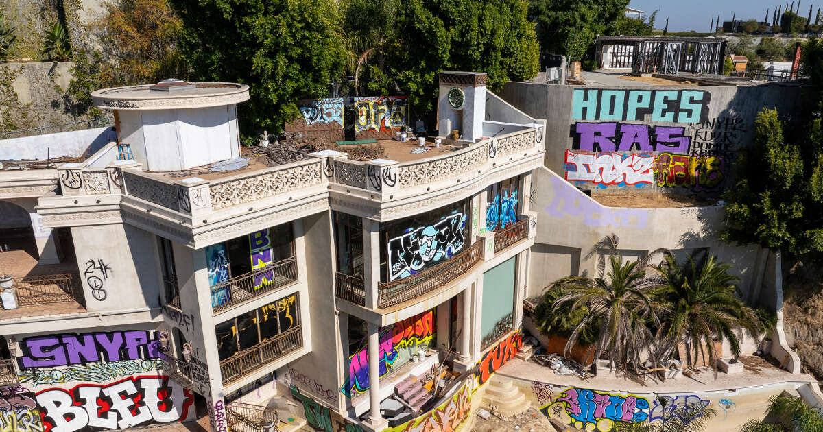 Two abandoned mansions owned by a Hollywood producer are covered in grafitti 