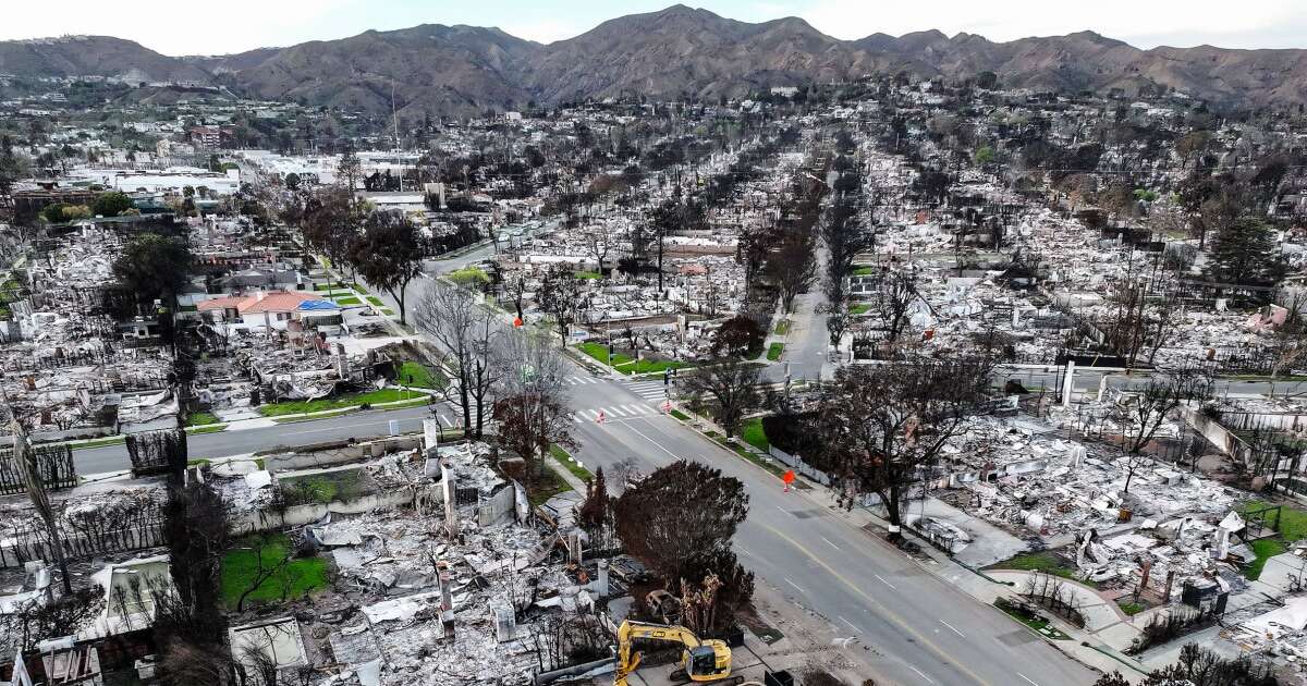 LA officials issue evacuation warnings for wildfire-affected areas ahead of heavy rain