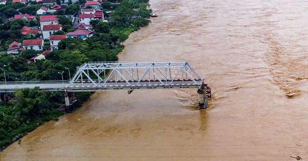 Flooding sweeps away a bus and a bridge collapses in Vietnam as storm deaths rise to 59