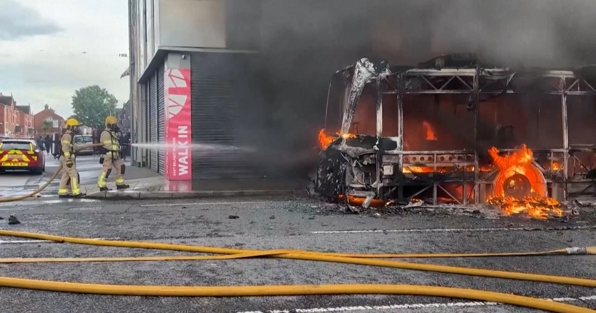 Protesters set fire to bus as unrest continues after knife attack