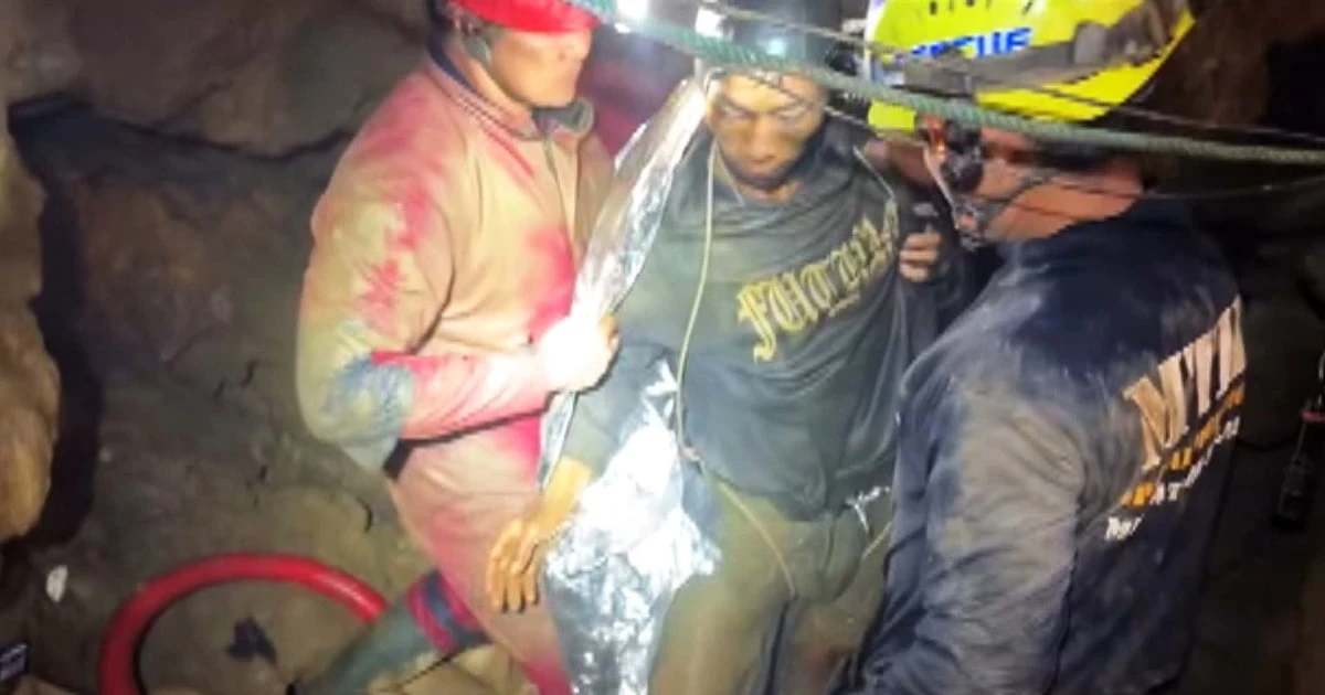 Video shows first of five men trapped in Laos cave rescued
