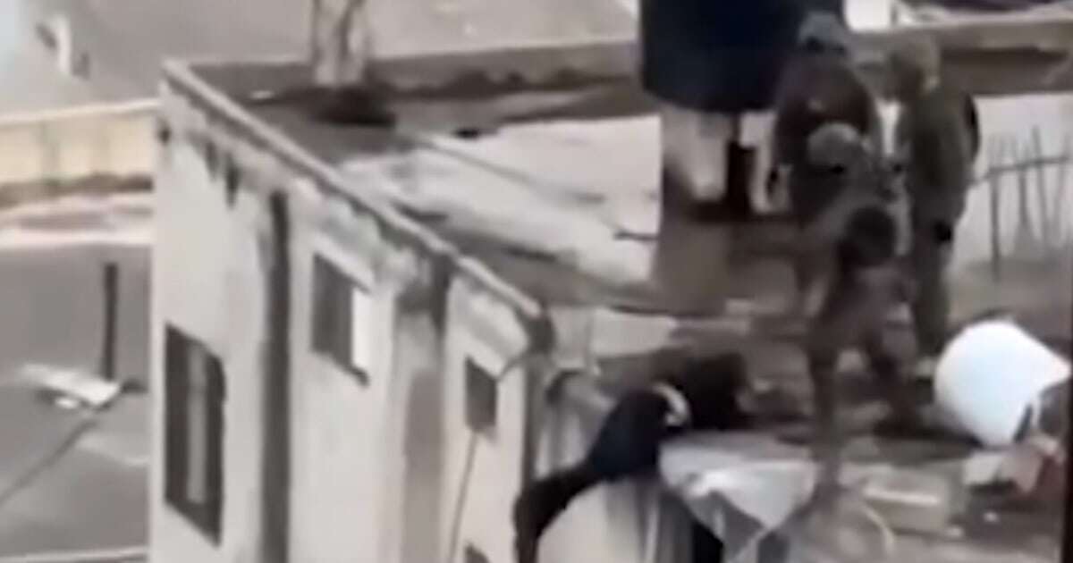 Disturbing video shows Israeli soldiers tipping body of Palestinian man off roof