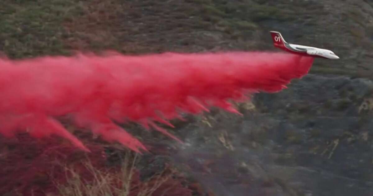 Crews fight Malibu fire from the air as winds die down