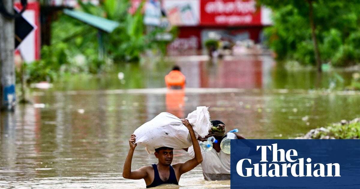 Bangladeshis taking refuge in emergency shelters after heavy flooding