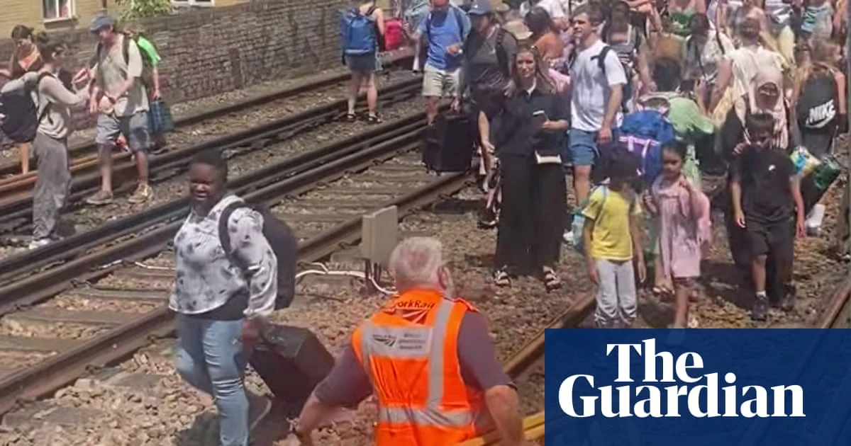 Evacuated London train passengers forced to walk along tracks on hottest day of year