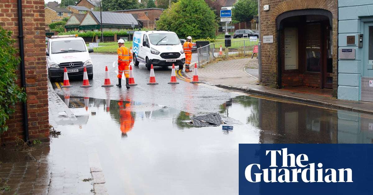 UK weather: commuters face travel disruption after heavy rainfall