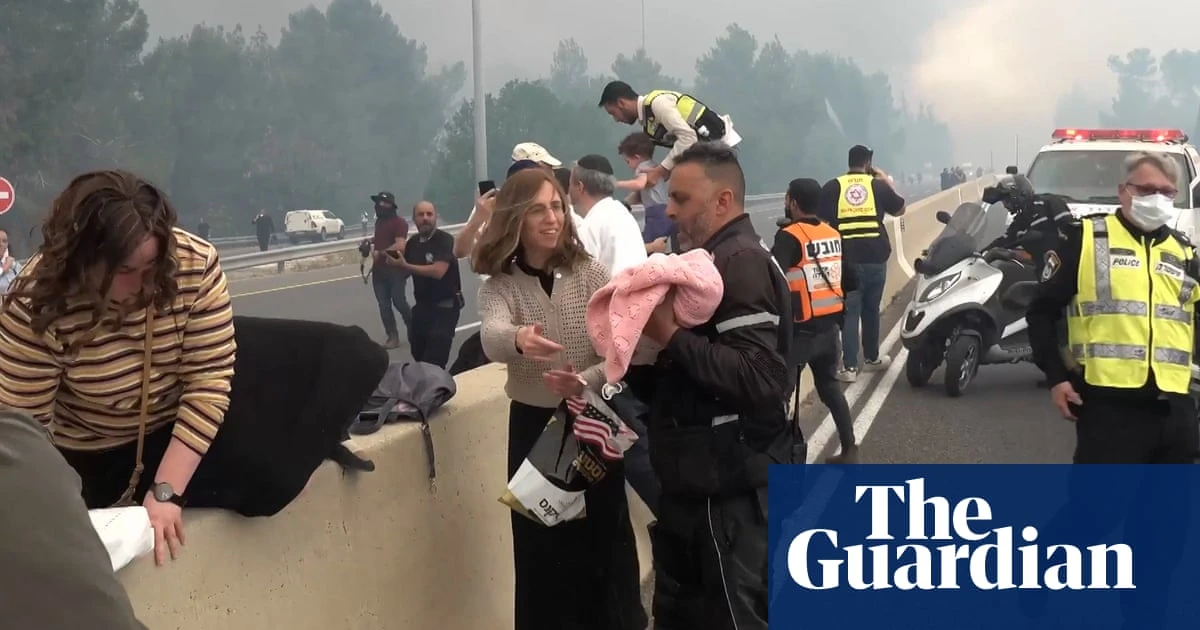 Motorists abandon cars as 'worst wildfire in decades' rages near Jerusalem – video