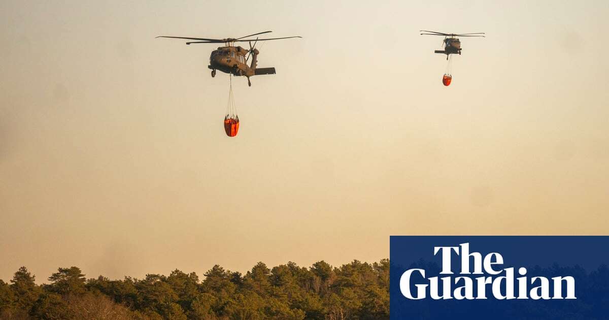 New York: firefighters continue to battle wind-driven brush fire on Long Island