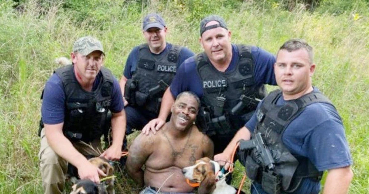 White police officers spark fury after posing for photo with black suspect they'd arrested