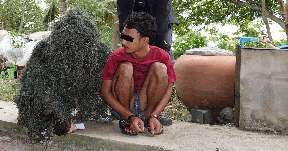 Moment cop disguised as bush arrests suspected child rapist in Thailand