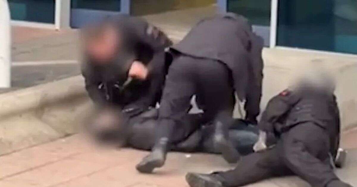 Police filmed at Manchester Airport 'kicking and punching' arrested man pinned to ground