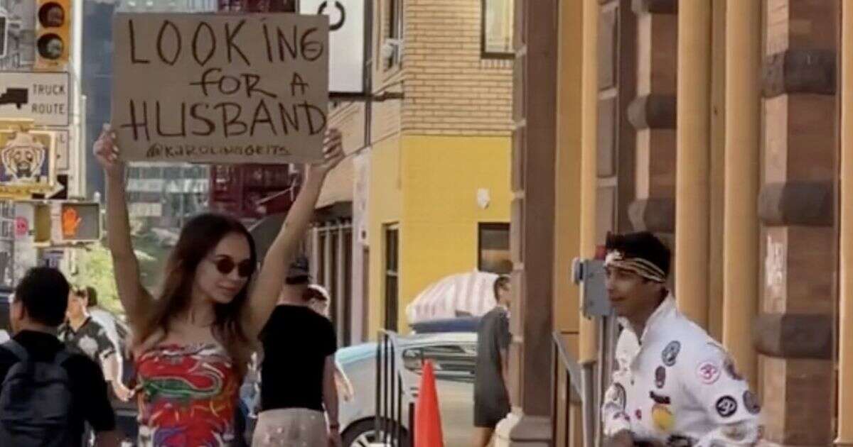 Woman fed up with dating apps takes to street with bold sign - and is swept off her feet