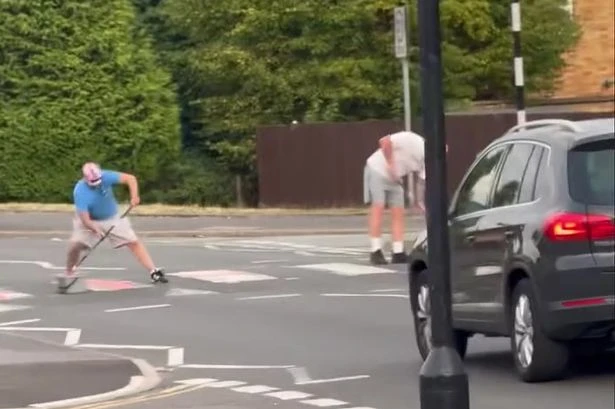 Men in St George flag masks paint on zebra crossing as people say 'it's not English'