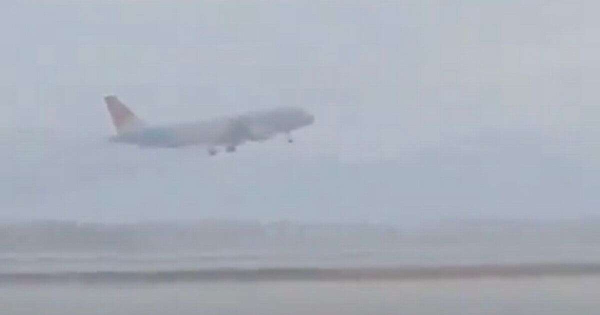 Dramatic moment pilot of packed passenger jet aborts his landing during storm