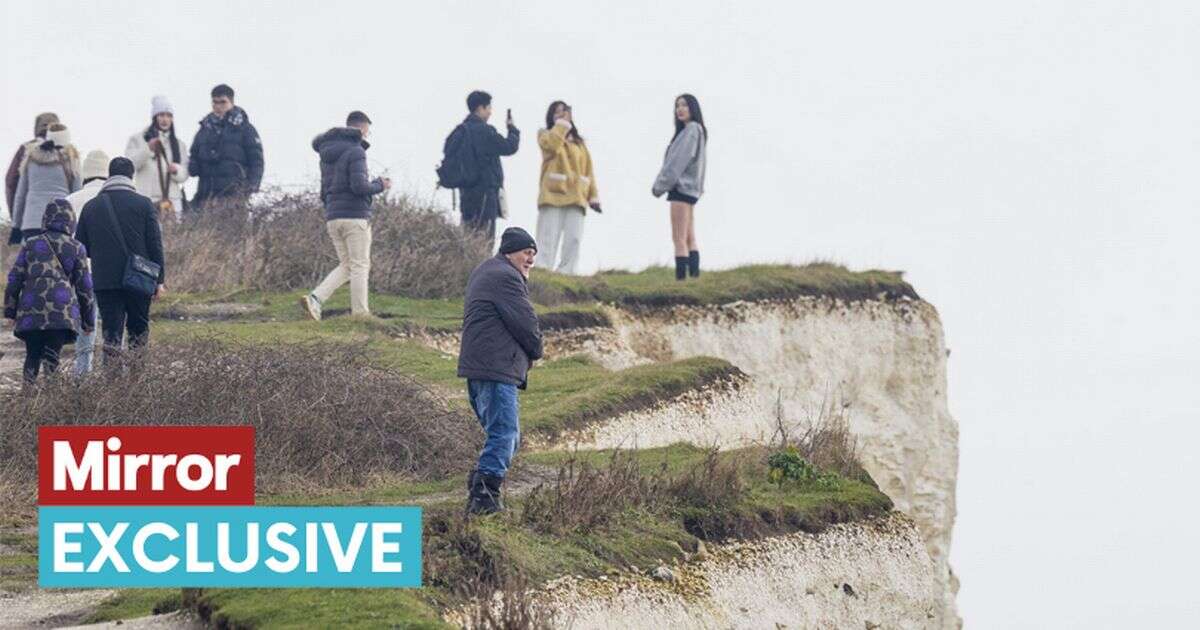 Moment tourists dice with death taking selfies on crumbling Sussex cliff edge