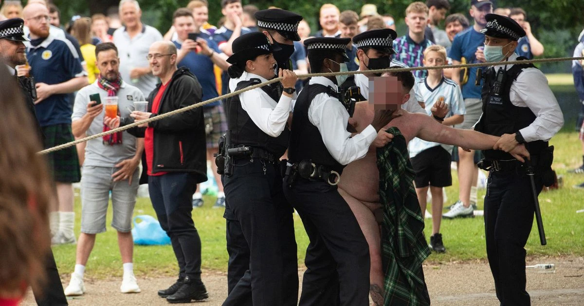 Scotland football fans splash naked and sing in the rain in London-wide party