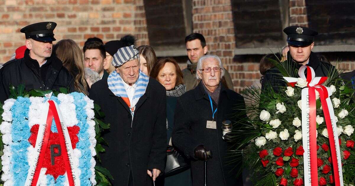 Emotional scenes as Holocaust survivors visit 'Death Wall' in Auschwitz to light candles of remembrance