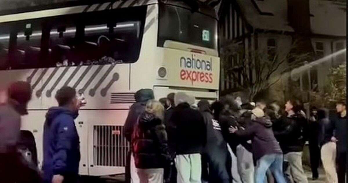 Terrifying moment National Express coach slips on icy road as locals try to stop it