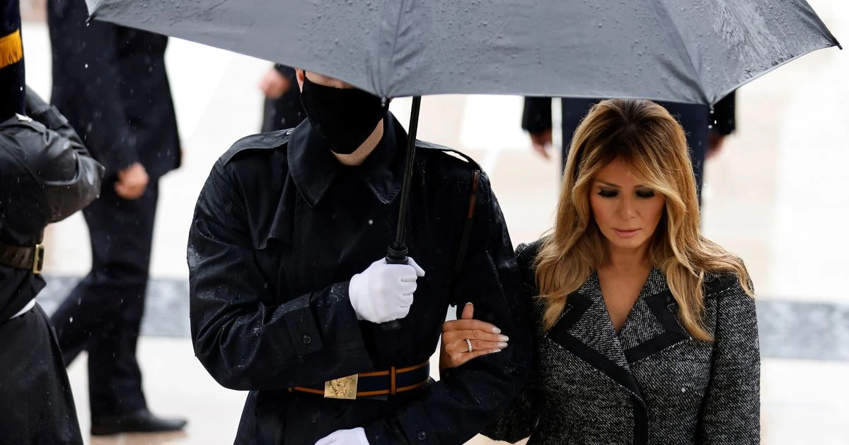 Melania Trump breaks social distancing to hold soldier's arm as President stands apart