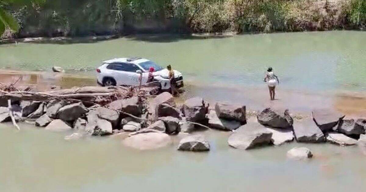 Women slammed for posing for snaps at river's dangerous crocodile crossing point