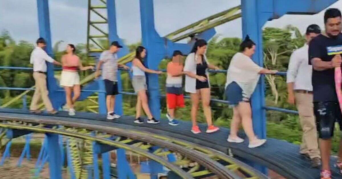 Moment stranded thrill-seekers forced to flee broken rollercoaster on precarious track