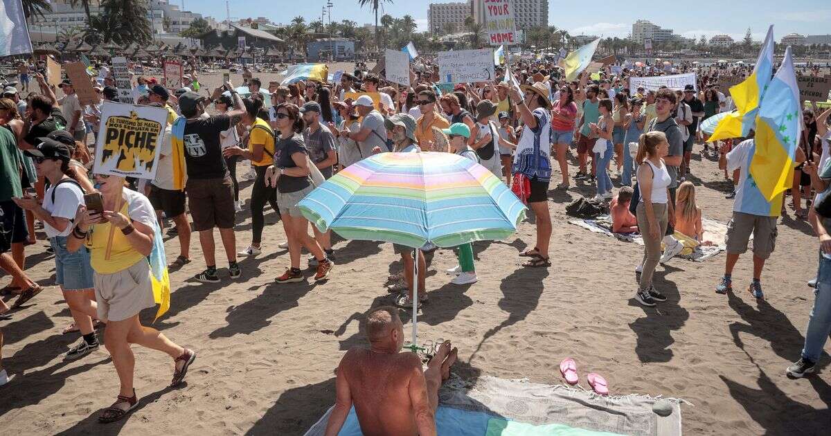 Brits sunbathing in Lanzarote and Tenerife surrounded by locals demanding they 'go home'