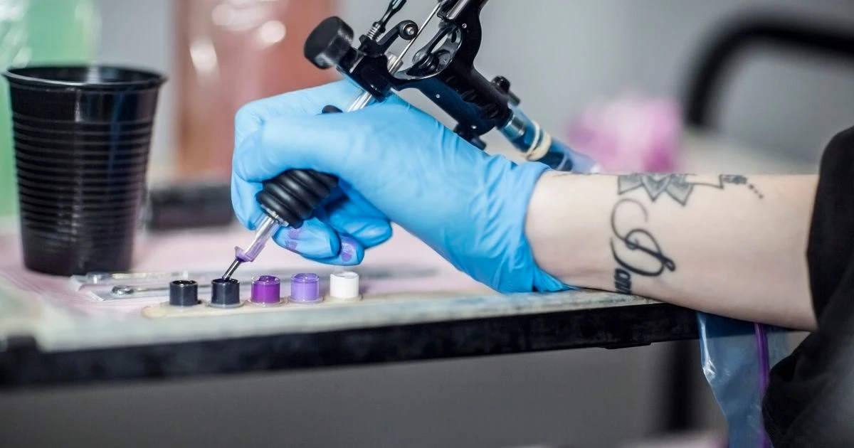 Dad labelled 'gross' for getting poo tattoos with his kids' names on his leg