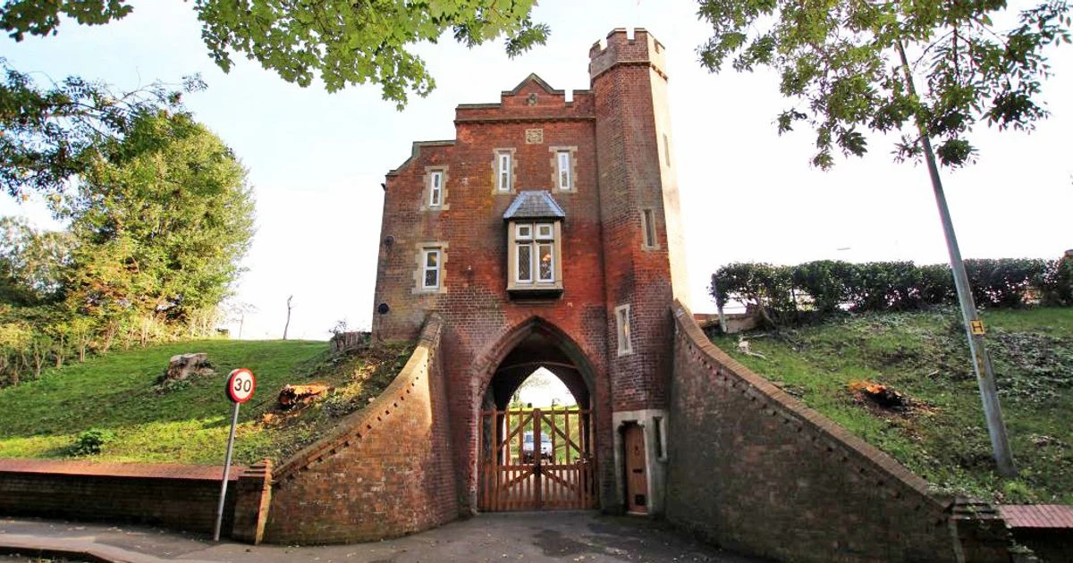 Spooky cemetery gatehouse with turret overlooking graveyard on sale for £350k