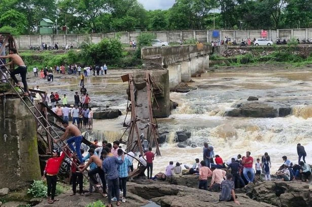 One person dead as major bridge at tourist hotspot collapses and several swept away