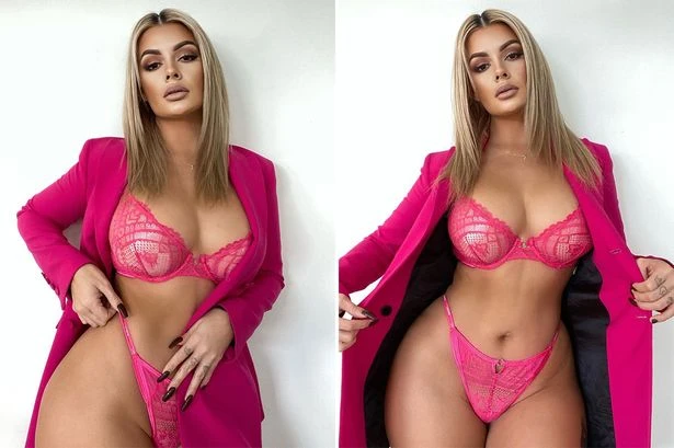 Model mixes business with pleasure by flashing lingerie under powerful suit