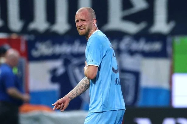Footballer rushed to hospital with 'potentially life-threatening' injury after horror collision