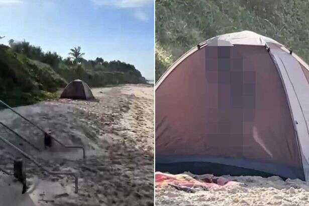 Couple caught in the act on sandy beach but at least they brought a tent