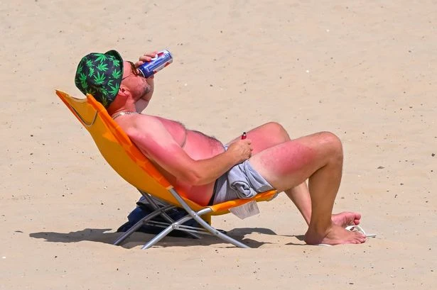 Britain’s coolest man sips a beer as he enjoys the scorching sunshine