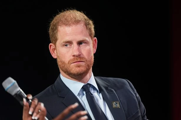 Prince Harry hurried out of court by bodyguards as woman screams at him