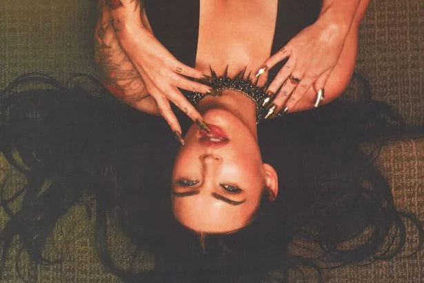 Megan Fox's boobs dangerously close to escaping bra as she flips upside down