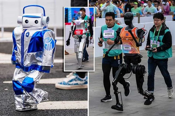 Robot runners take on humans in world-first marathon as droid has horror fall at start line