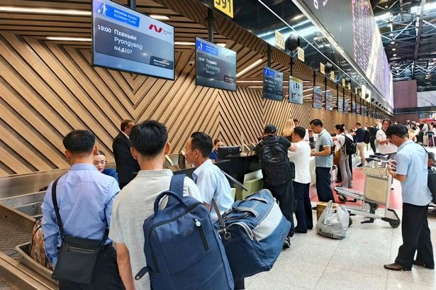 North Korean officials check Russian tourists' temperature upon arrival