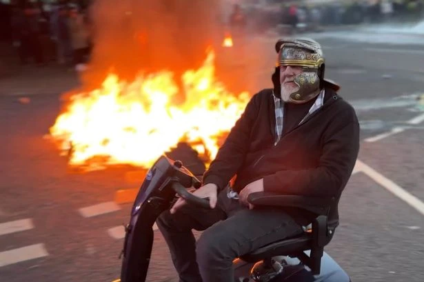 Watch: Bloke in Roman helmet on mobility scooter taunts cops during Ballymena riots