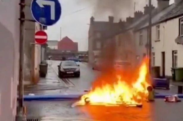 Riot police out for fourth night as fire on street and rocks thrown at cops in UK town