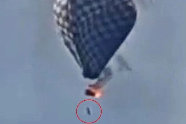 Man dies in hot air balloon fire as video shows him dangling on rope before falling