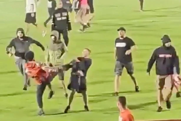 Balaclava hooligans storm pitch and attack their own players – wild footage shows