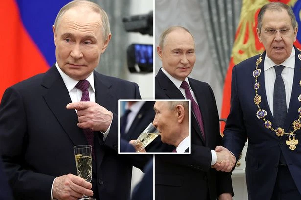 Putin downs champagne as he hands award to mouthpiece who threatened to nuke the UK