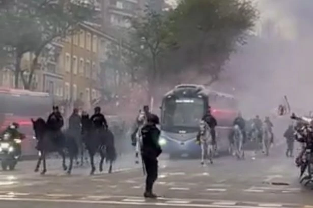 Real Madrid fans pack street and throw flares at team bus as Arsenal receive police escort