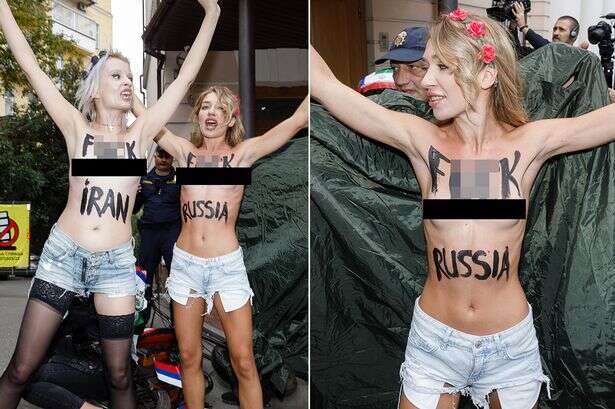 Topless protesters daub 'F**k Russia' on their chests as security guards try to cover up