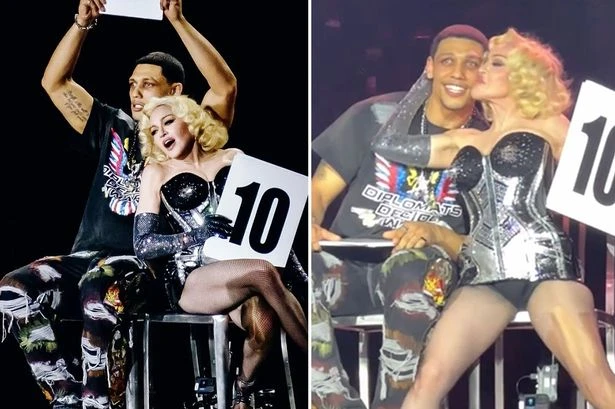 Madonna caught in steamy smooch as she kisses toyboy on stage after angering fans
