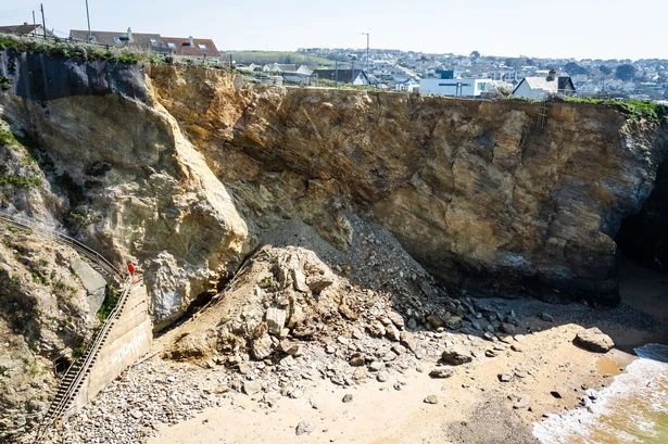 Massive cliff collapses as 2,000 tonnes of rock plummet next to luxury development