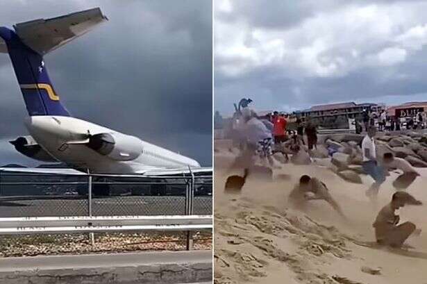 Jet blast blows picture-taking tourists into sea at 'world's most dangerous airport'