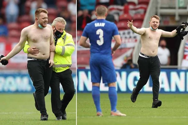 England streaker caught by stewards puts Covid mask back on while being led away